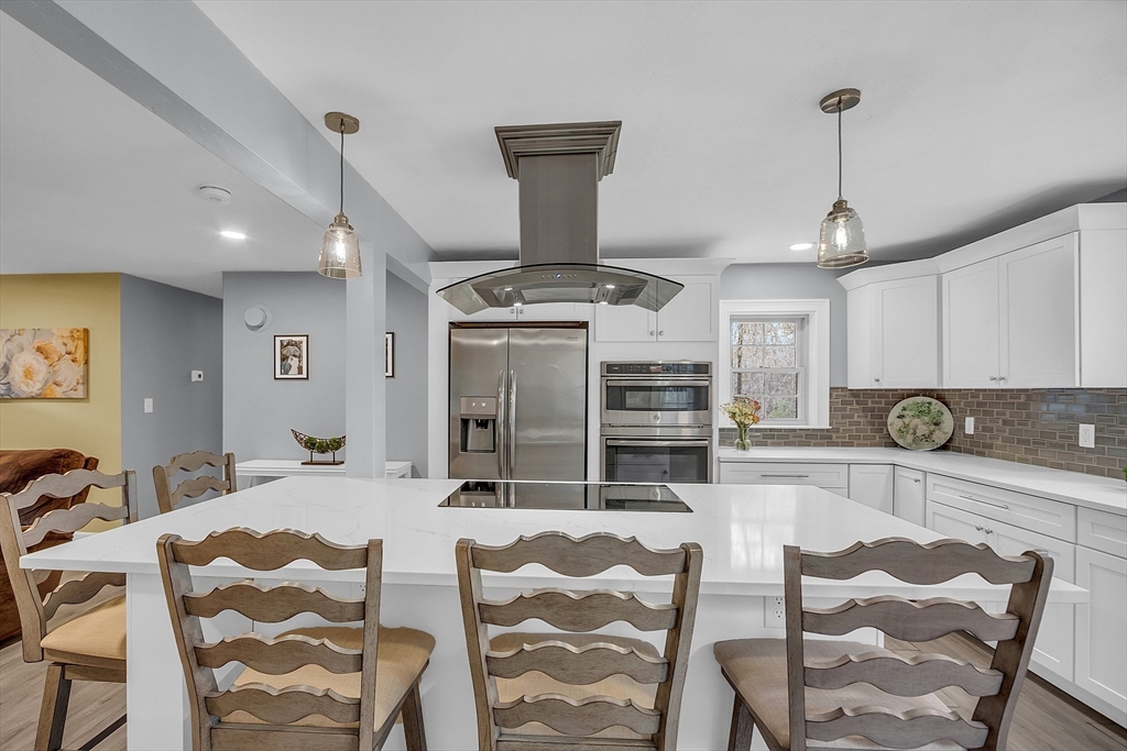 35 Bathrick Westminster, MA 01473 - Photo 9 of 36 a view of a kitchen with kitchen island stainless steel appliances wooden floor dining table and chair