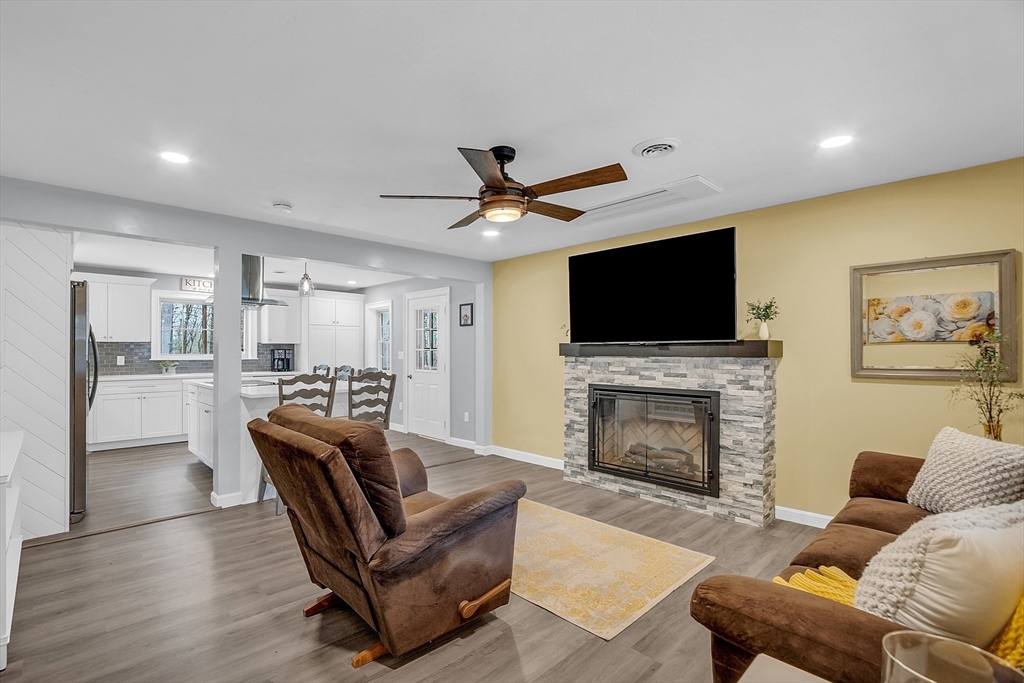 35 Bathrick Westminster, MA 01473 - Photo 10 of 36 a living room with furniture a fireplace and a flat screen tv