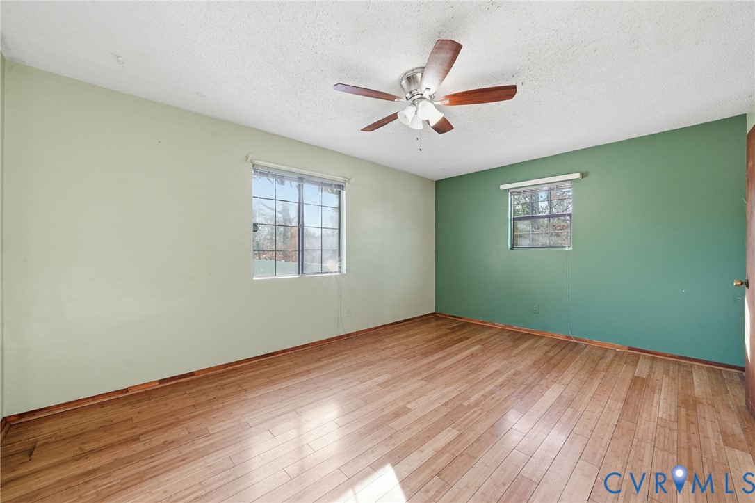 3881 Strawberry Plains Road Williamsburg, VA 23188 - Photo 11 of 29 a view of an empty room with window and wooden floor
