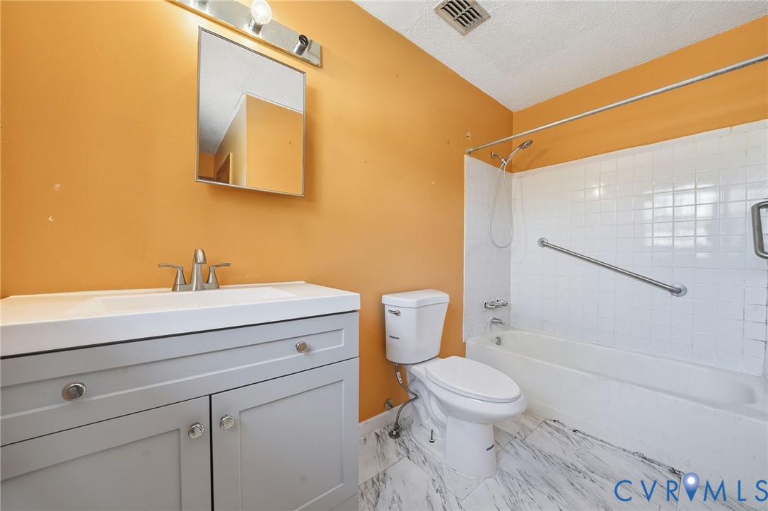 3881 Strawberry Plains Road Williamsburg, VA 23188 - Photo 15 of 29 a bathroom with a toilet a sink and a shower