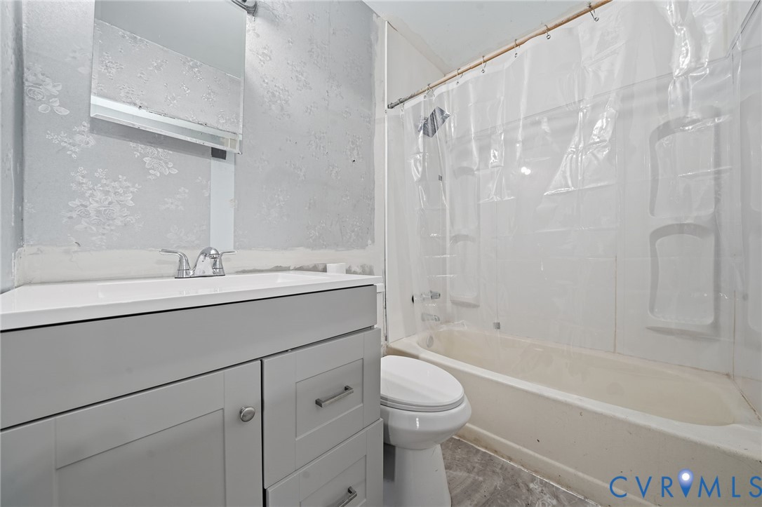 3881 Strawberry Plains Road Williamsburg, VA 23188 - Photo 16 of 29 a bathroom with a sink a toilet and a bathtub