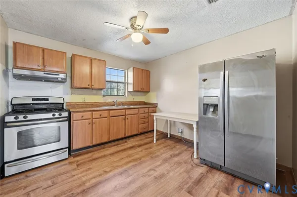 a kitchen with a stove a sink and a refrigerator