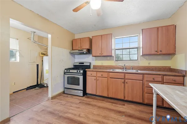 a kitchen with stainless steel appliances granite countertop a stove and a sink