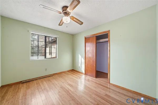 wooden floor in an empty room with a window