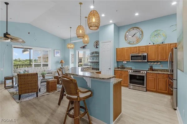 a kitchen with stainless steel appliances granite countertop a stove and a refrigerator