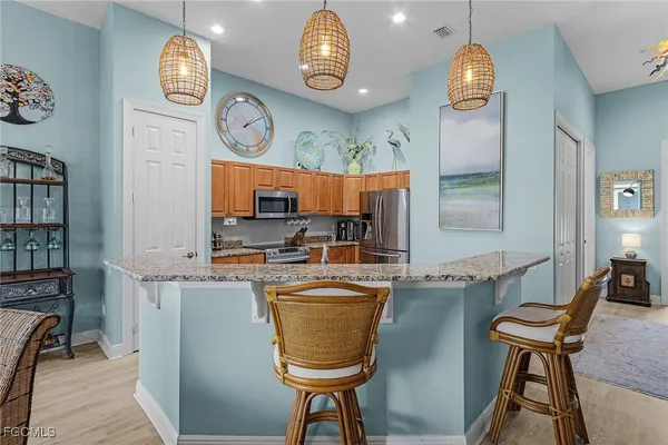 a view of a kitchen with fridge and outdoor seating