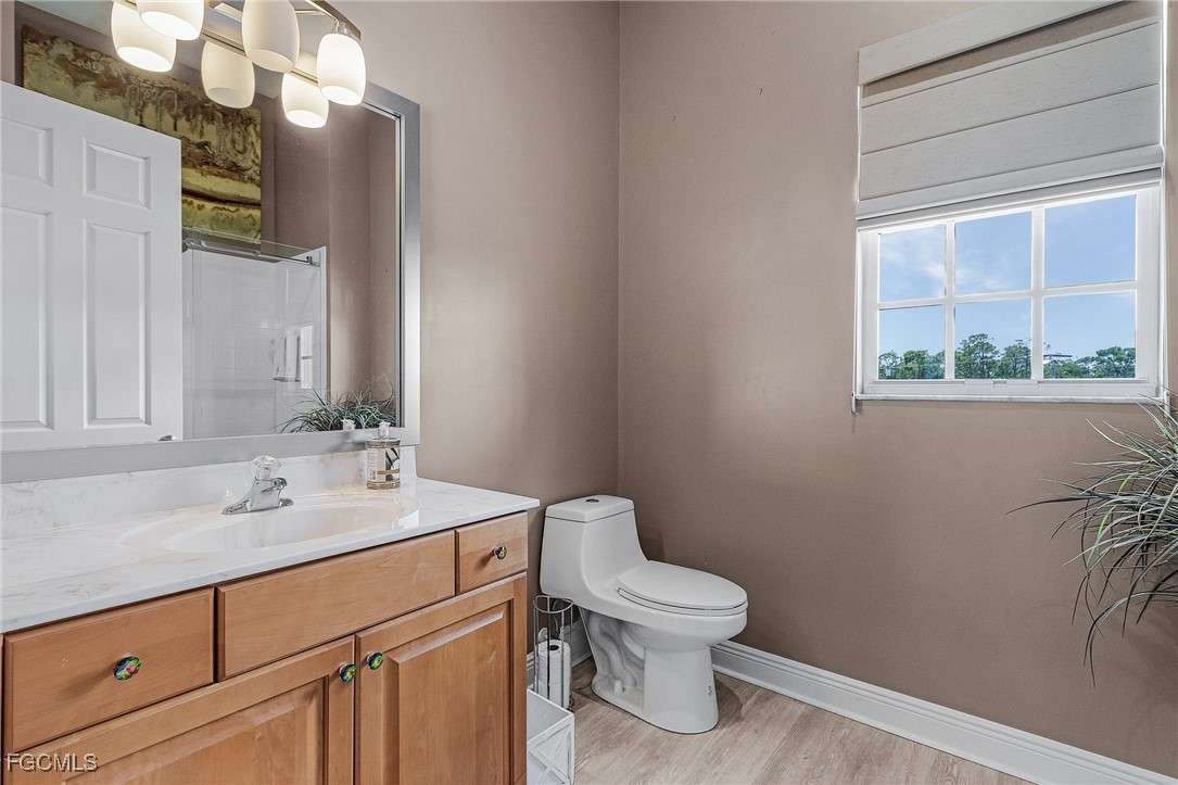 3728 Agualinda Boulevard, Unit 304 Cape Coral, FL 33914 - Photo 14 of 25 a bathroom with a toilet sink and mirror