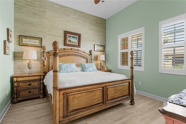 a bedroom with a bed and a tv on the dresser