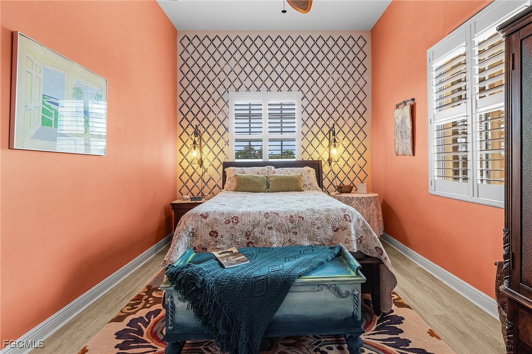 3728 Agualinda Boulevard, Unit 304 Cape Coral, FL 33914 - Photo 18 of 25 a bedroom with a bed and a window