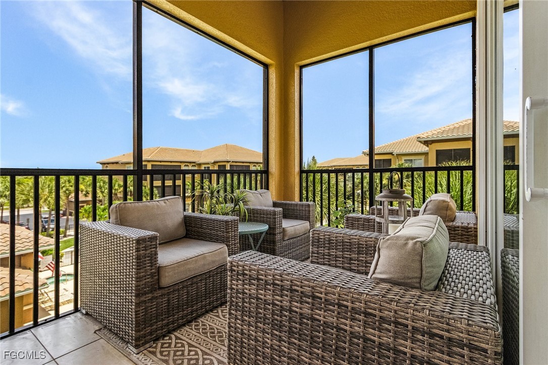 3728 Agualinda Boulevard, Unit 304 Cape Coral, FL 33914 - Photo 20 of 25 a balcony with couch and outside view