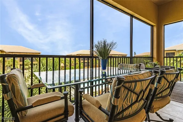a view of a chairs and table in the balcony