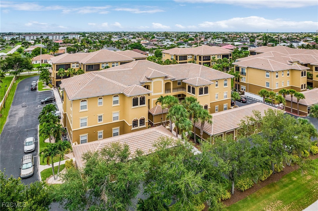 3728 Agualinda Boulevard, Unit 304 Cape Coral, FL 33914 - Photo 21 of 25 an aerial view of residential houses with outdoor space and parking