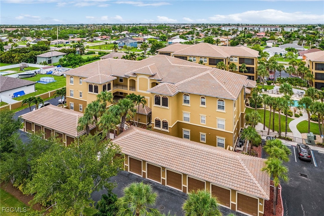 3728 Agualinda Boulevard, Unit 304 Cape Coral, FL 33914 - Photo 25 of 25 an aerial view of multiple houses with a yard