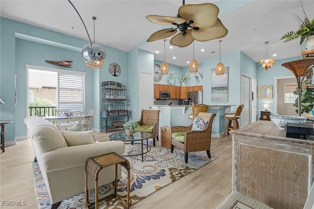 a living room with furniture a chandelier and a window