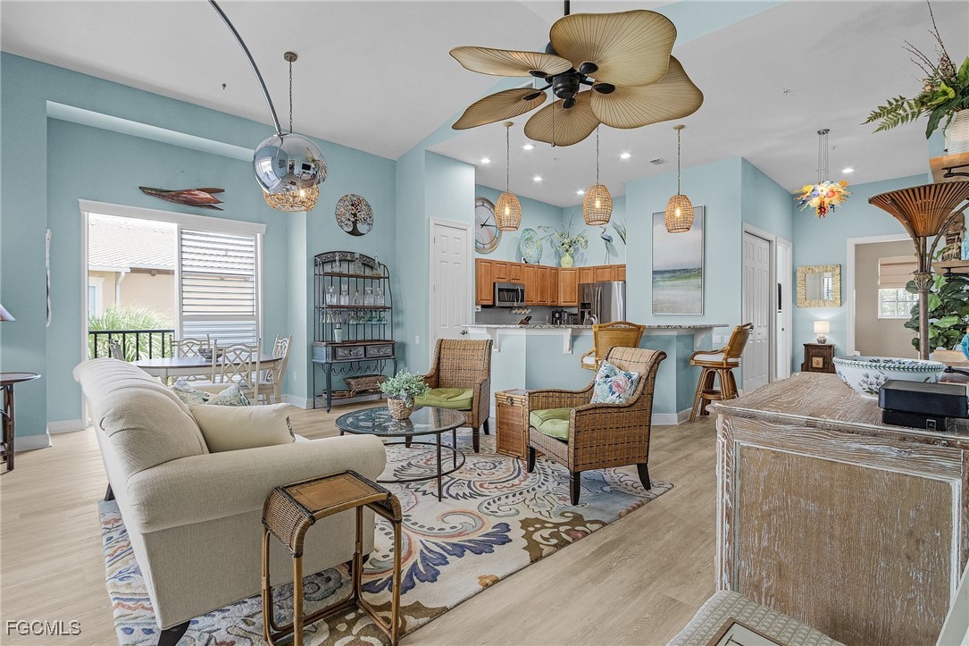 3728 Agualinda Boulevard, Unit 304 Cape Coral, FL 33914 - Photo 3 of 25 a living room with furniture a chandelier and a window