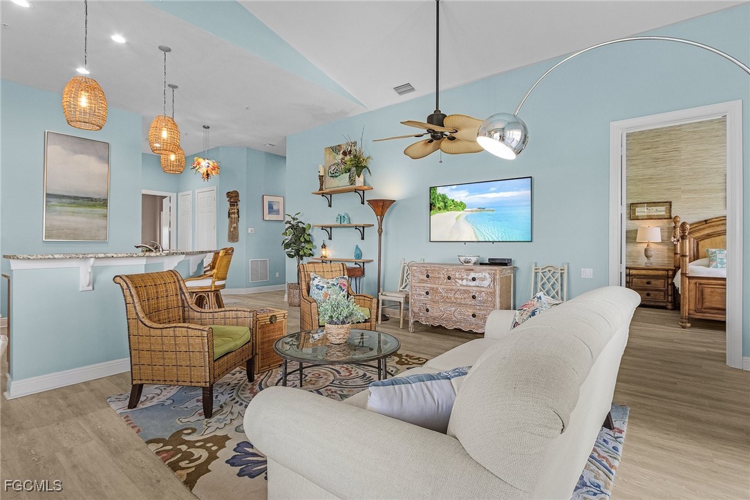 3728 Agualinda Boulevard, Unit 304 Cape Coral, FL 33914 - Photo 6 of 25 a living room with dining room and a chandelier