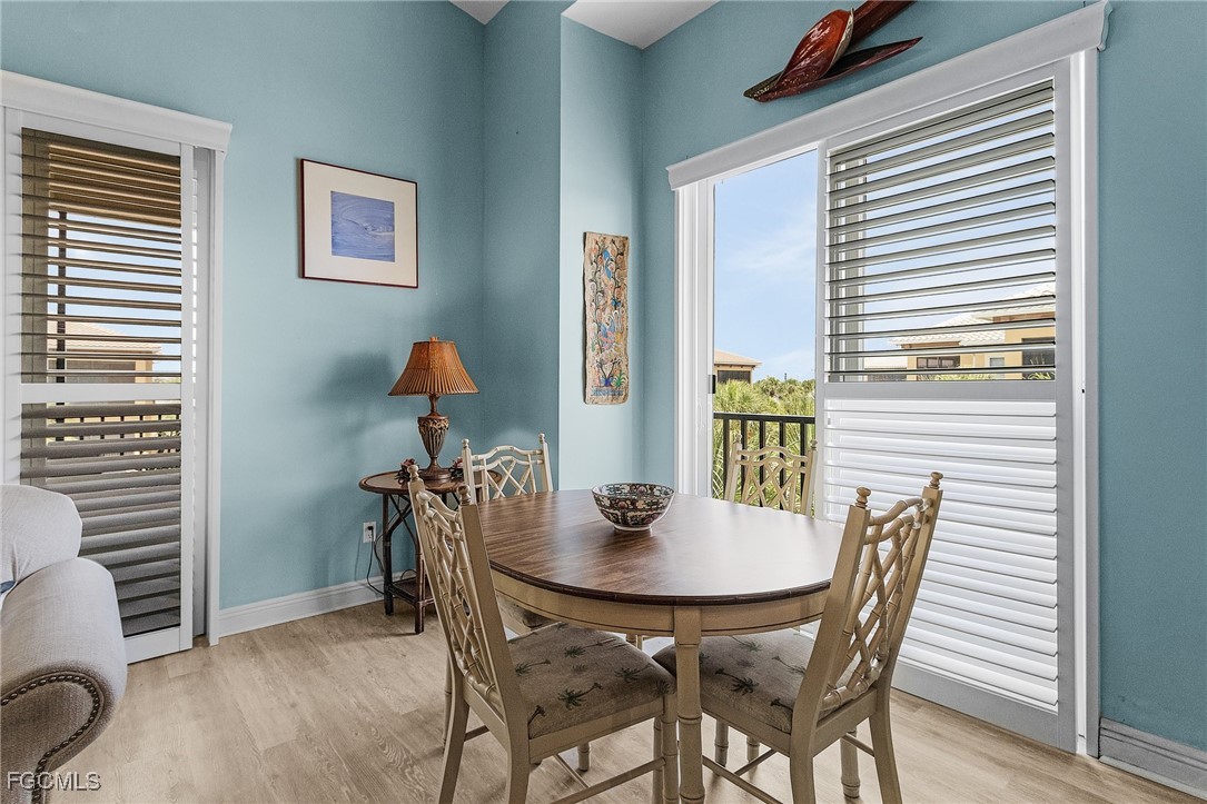 3728 Agualinda Boulevard, Unit 304 Cape Coral, FL 33914 - Photo 7 of 25 a view of a dining room with furniture and wooden floor