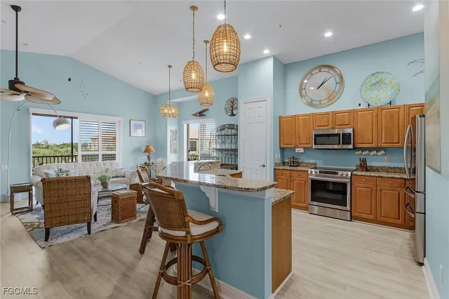 a kitchen with stainless steel appliances granite countertop a stove and a refrigerator