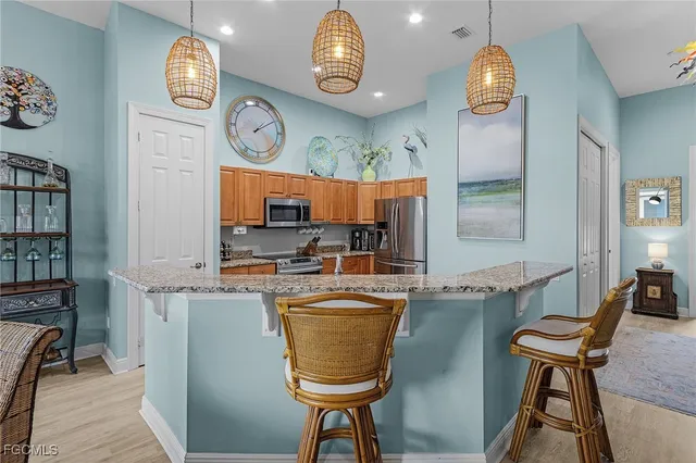 a view of a kitchen with fridge and outdoor seating