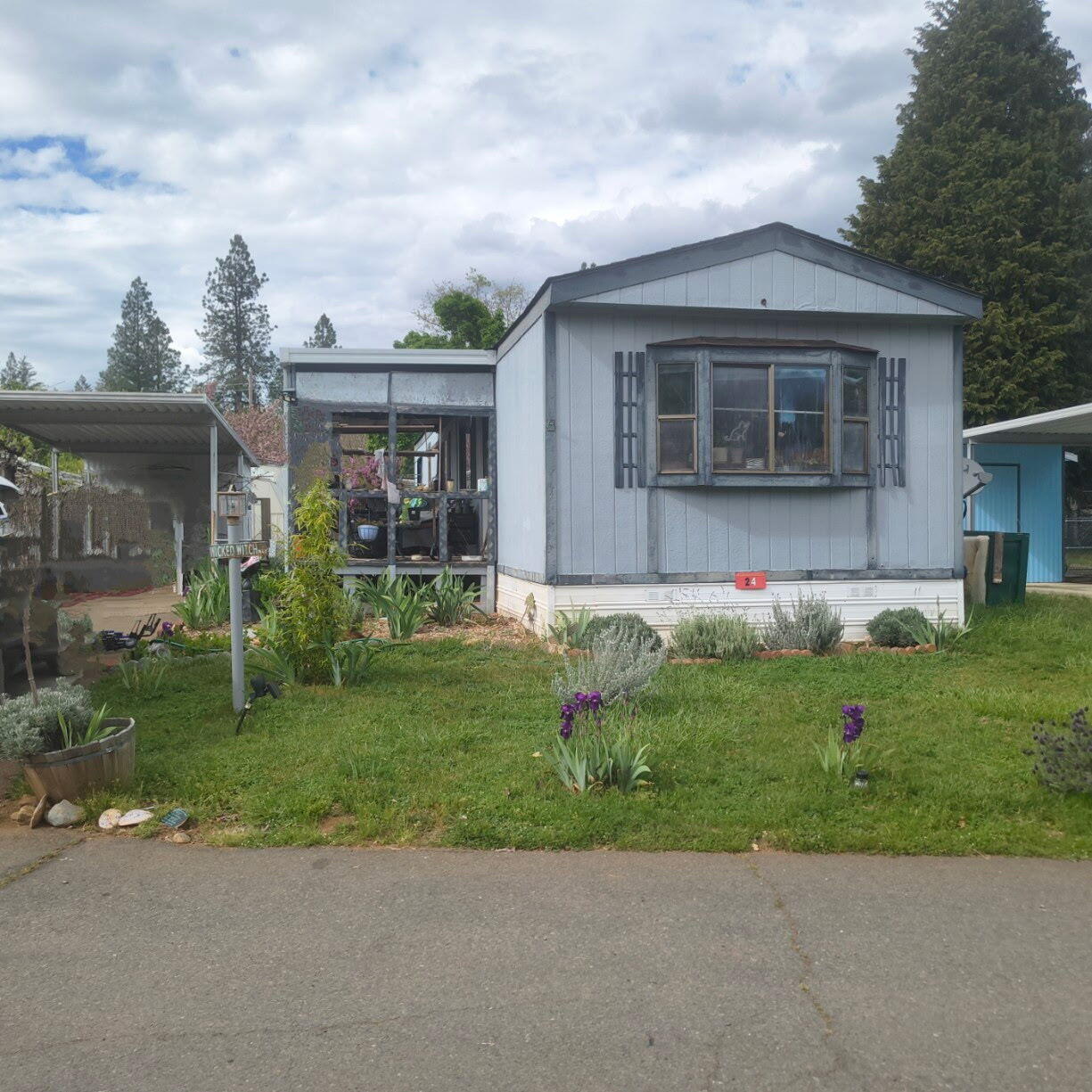 222 Ollis Road, Unit 24 Cave Junction, OR 97523 - Photo 1 of 6 front view of house with a yard