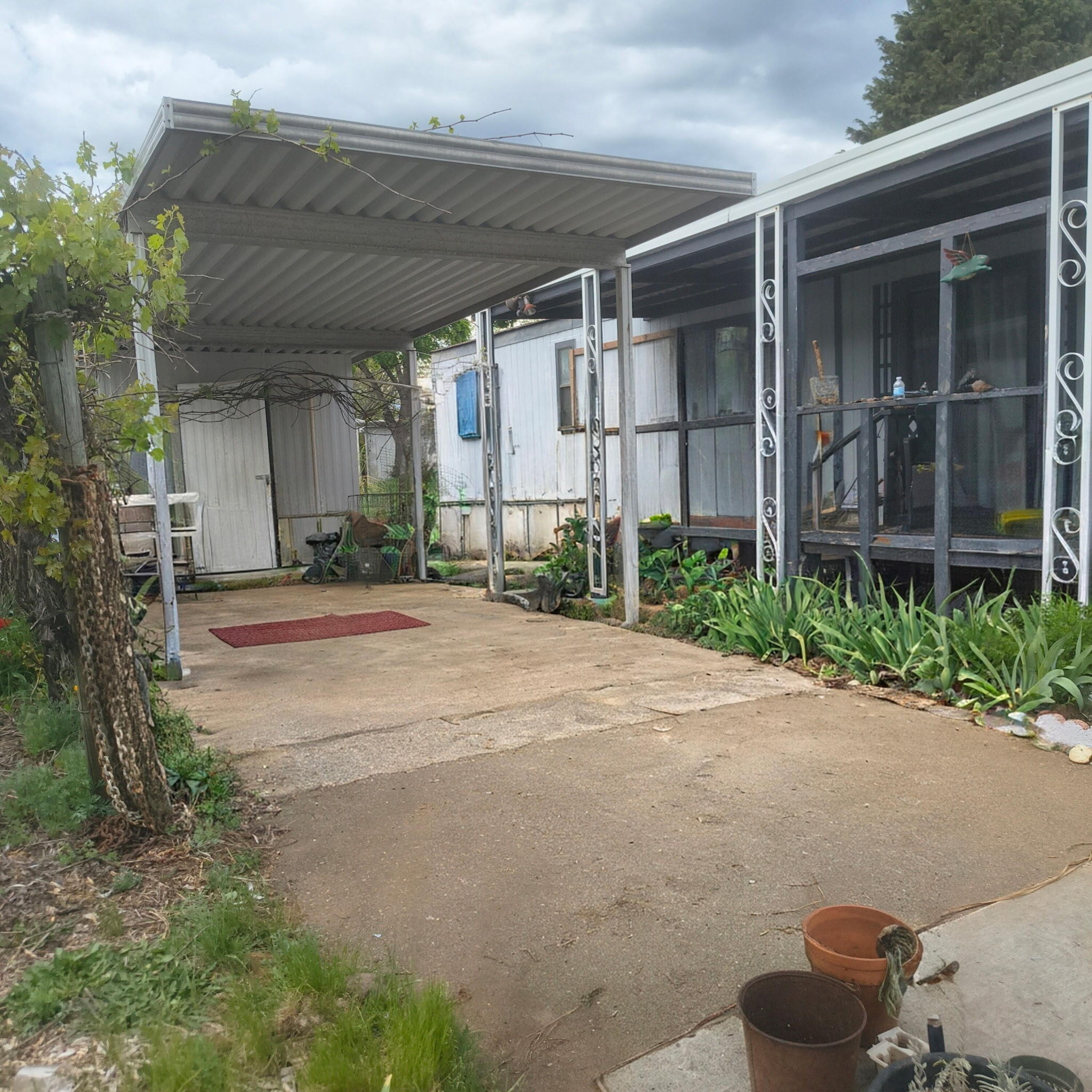 222 Ollis Road, Unit 24 Cave Junction, OR 97523 - Photo 2 of 6 a view of a house with a yard