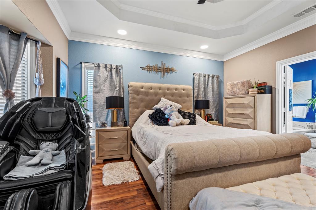 3910 Kingsferry Court Arlington, TX 76016 - Photo 13 of 32 a bedroom with a bed and wooden floor