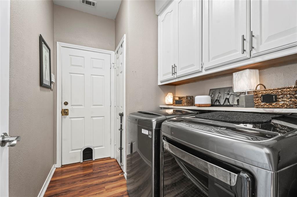 3910 Kingsferry Court Arlington, TX 76016 - Photo 17 of 32 a kitchen with a stove and white cabinets