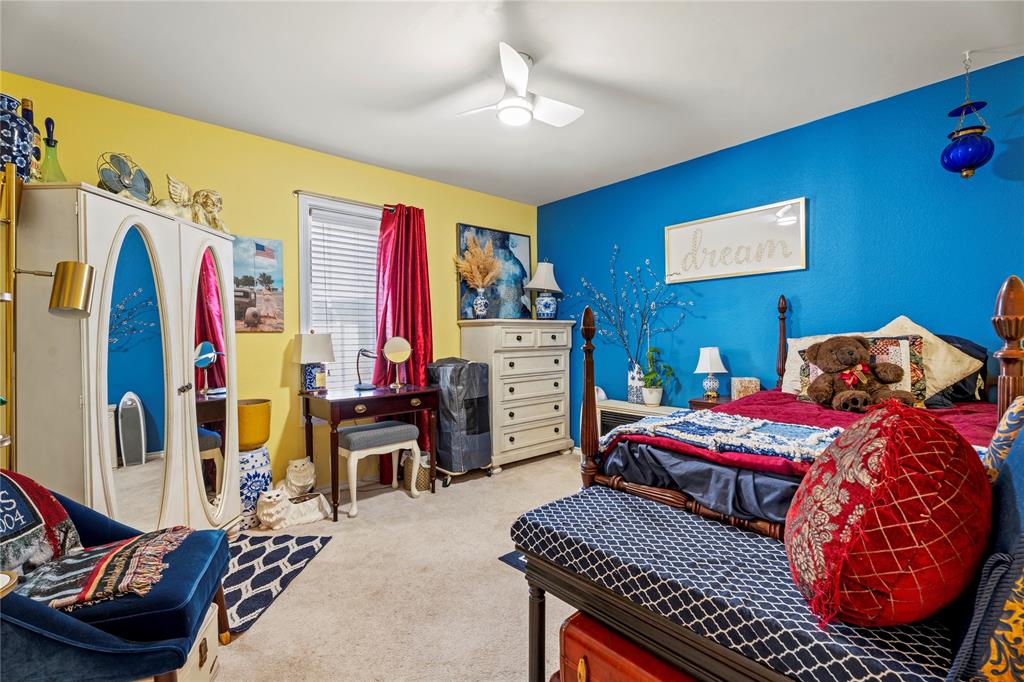3910 Kingsferry Court Arlington, TX 76016 - Photo 22 of 32 a bedroom with a bed and a chandelier