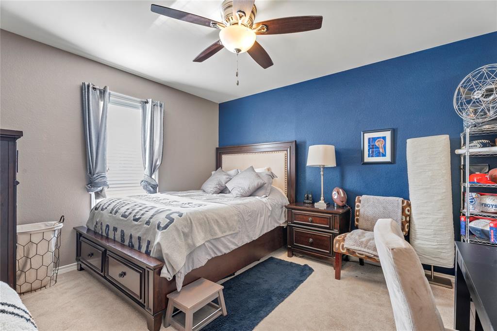 3910 Kingsferry Court Arlington, TX 76016 - Photo 23 of 32 a bed room with a bed and a chandelier