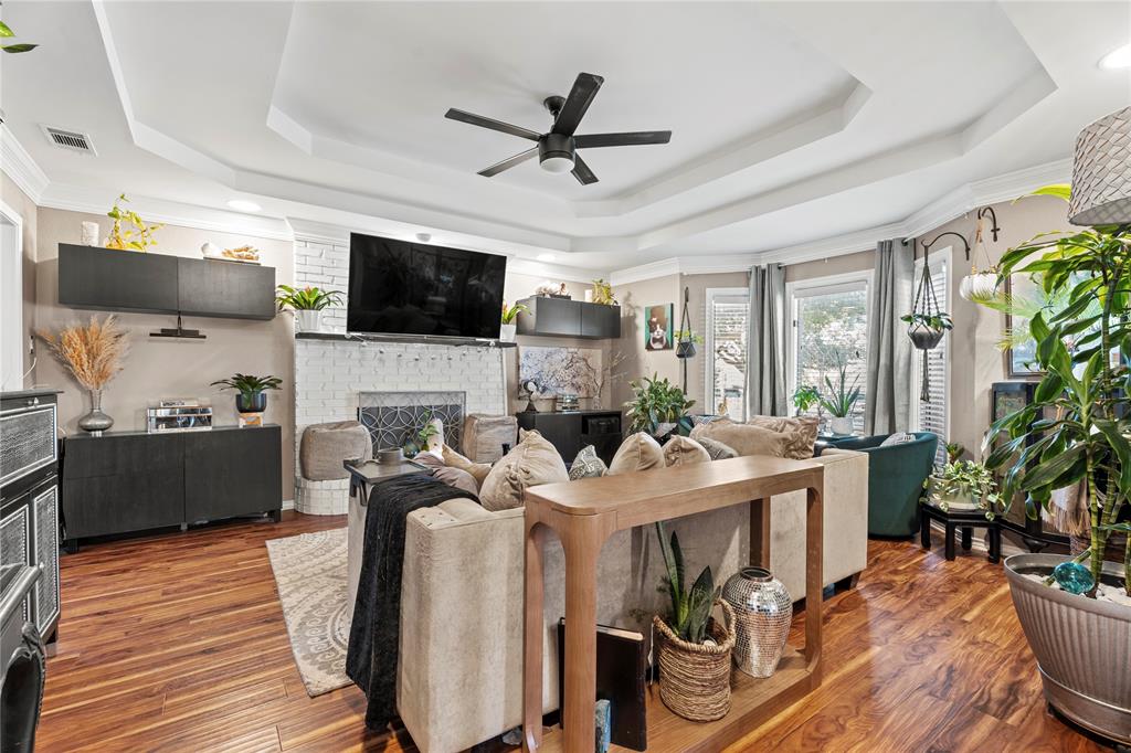 3910 Kingsferry Court Arlington, TX 76016 - Photo 5 of 32 a living room with furniture a flat screen tv and a fireplace