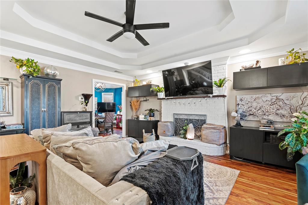 3910 Kingsferry Court Arlington, TX 76016 - Photo 7 of 32 a living room with furniture a flat screen tv and a fireplace