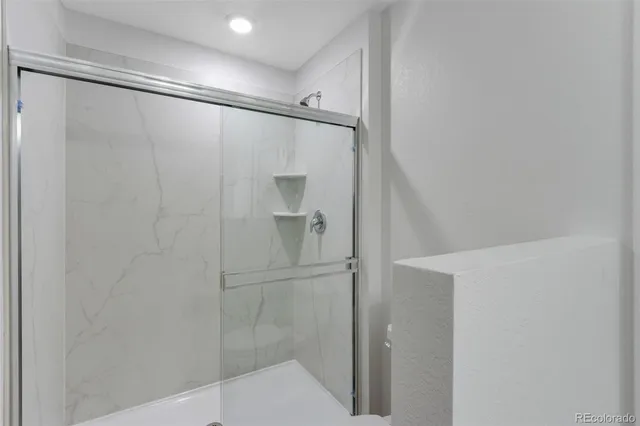 a bathroom with a glass shower door