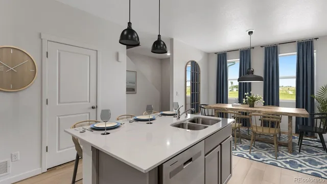 a kitchen with a sink a stove and chairs
