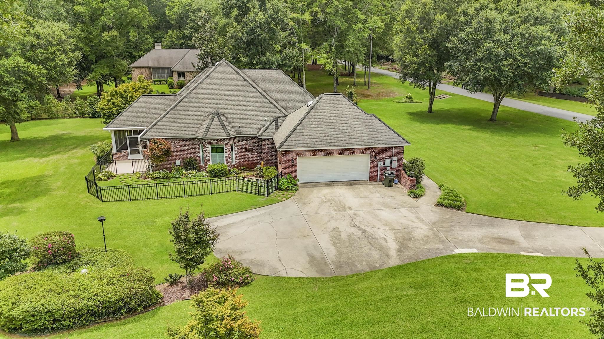 13612 Rue Royal Lane Silverhill, AL 36576 - Photo 57 of 65 View of front facade with brick siding, an attached garage, driveway, and a shingled roof