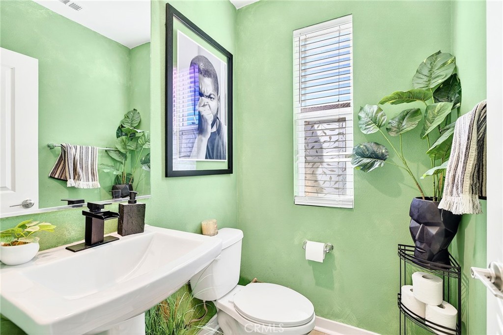 39400 Corvina Lane Temecula, CA 92591 - Photo 19 of 42 a bathroom with a toilet sink and mirror