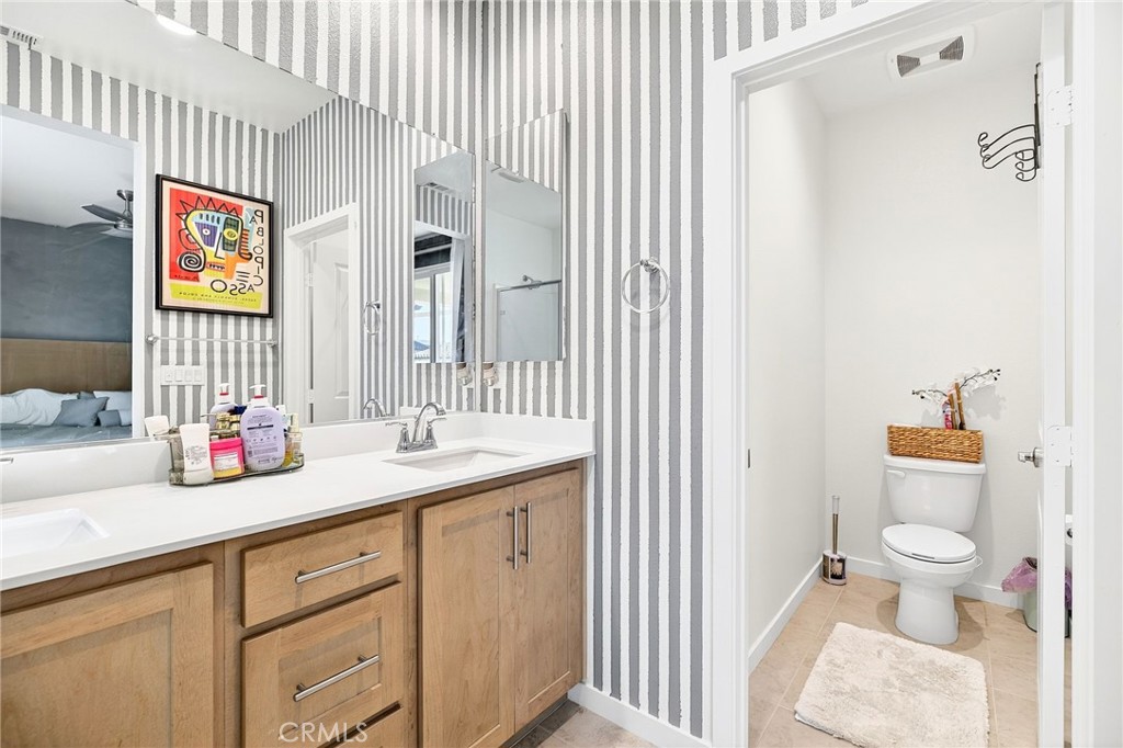 39400 Corvina Lane Temecula, CA 92591 - Photo 32 of 42 a bathroom with a sink a toilet and a mirror