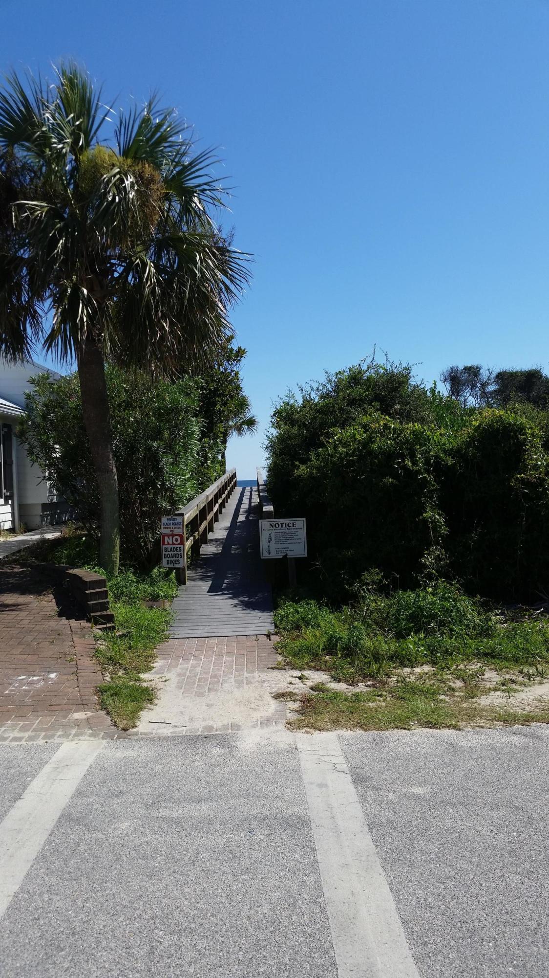 Lot 5 Sand Cliffs Dr Inlet Beach Inlet Beach, FL 32461 - Photo 2 of 10 a backyard of a house with a yard and outdoor seating