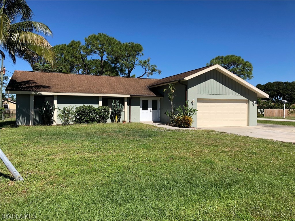 7535 Morgan Road Fort Myers, FL 33967 - Photo 1 of 19 a front view of a house with a yard