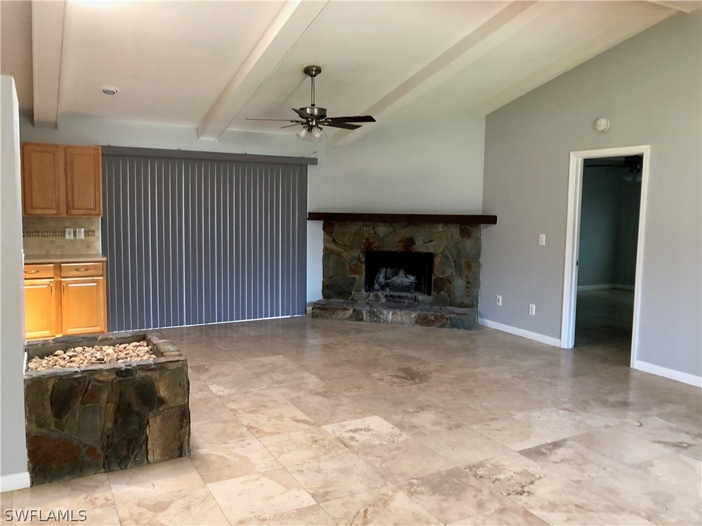7535 Morgan Road Fort Myers, FL 33967 - Photo 6 of 19 a view of empty room with a fireplace and fan