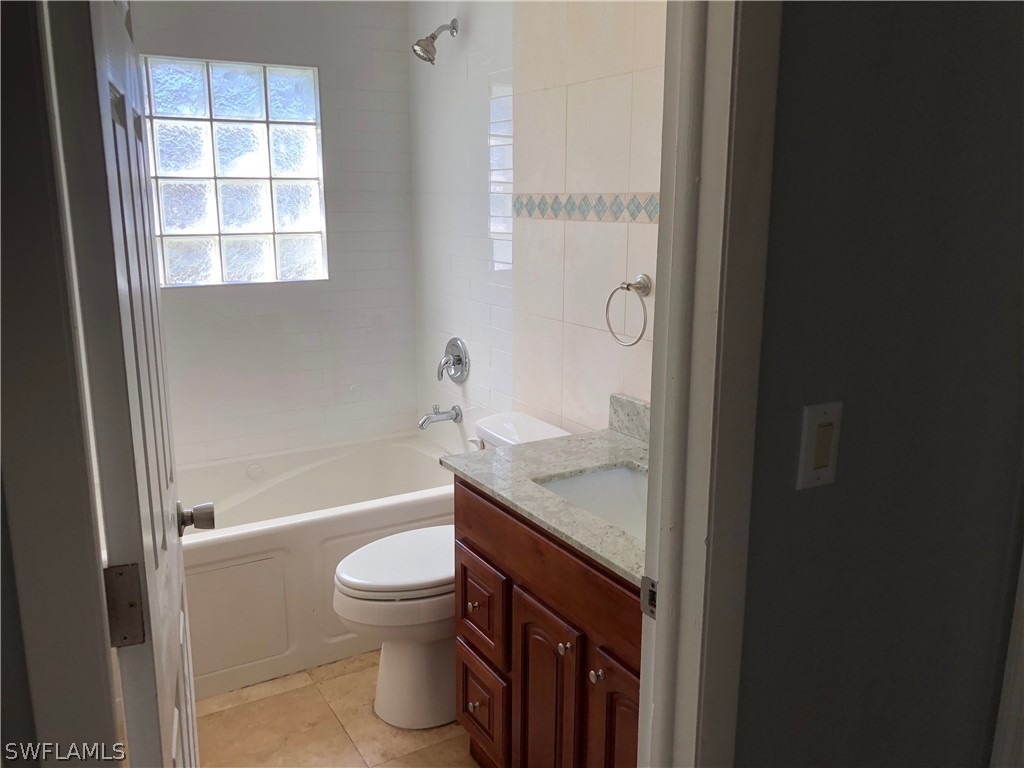 7535 Morgan Road Fort Myers, FL 33967 - Photo 10 of 19 a bathroom with a granite countertop toilet a sink and a bathtub