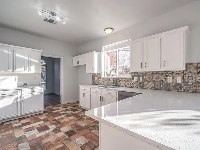 a kitchen with stainless steel appliances granite countertop a sink and cabinets