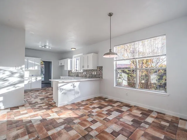 a kitchen with stainless steel appliances granite countertop a stove top oven a sink and a window