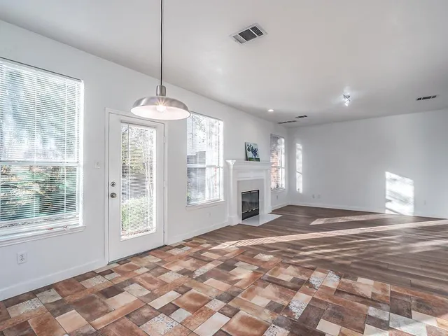 a view of empty room with a fireplace