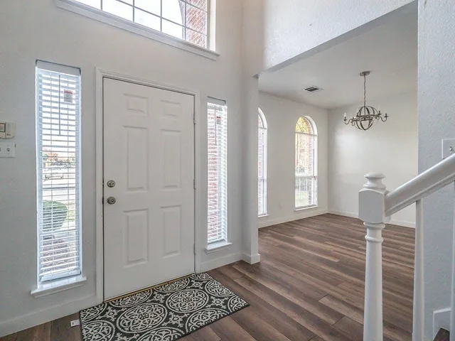 a view of an entryway with wooden floor
