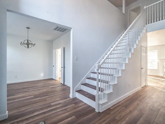 a view of entryway and hall with wooden floor