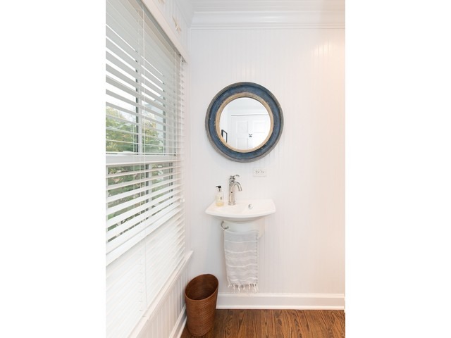 764 Locust Street Winnetka, IL 60093 - Photo 21 of 25 a bathroom with a sink a toilet and a mirror
