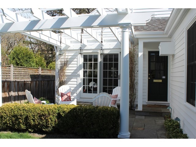 764 Locust Street Winnetka, IL 60093 - Photo 22 of 25 a view of a backyard with table and chairs under an umbrella