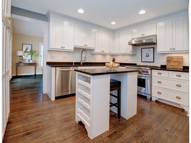 764 Locust Street Winnetka, IL 60093 - Photo 5 of 25 a kitchen with cabinets wooden floor and stainless steel appliances
