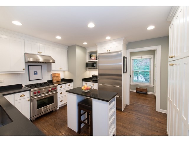 764 Locust Street Winnetka, IL 60093 - Photo 6 of 25 a kitchen that has a refrigerator a stove a sink and a cabinets