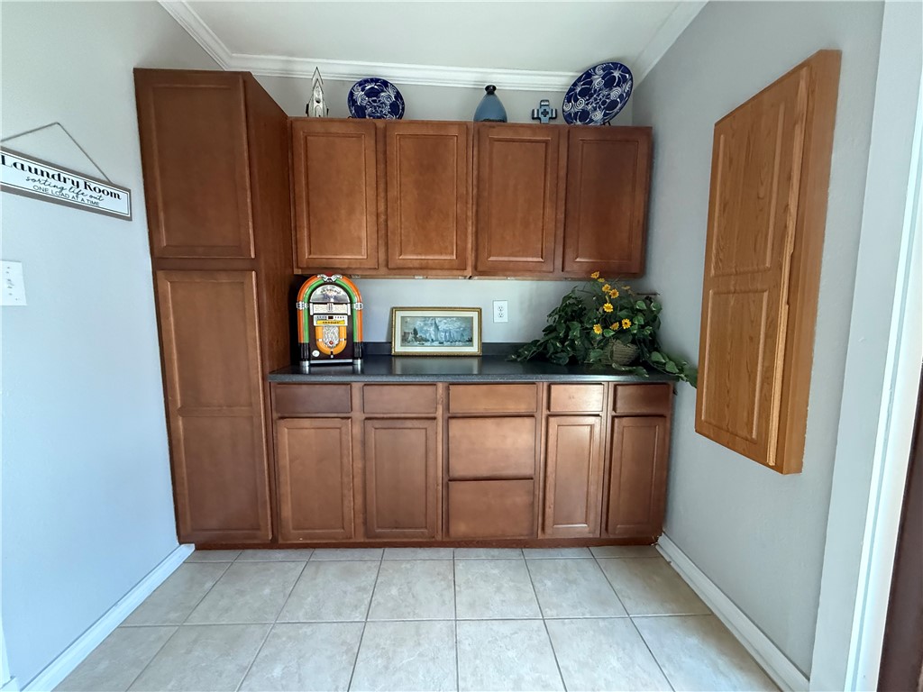 116 Sunset Drive Mathis, TX 78368 - Photo 14 of 40 a kitchen with stainless steel appliances a refrigerator and a cabinets